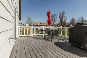 Wooden terrace with a residential view and outdoor dining space