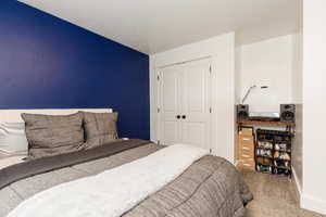 Carpeted bedroom featuring a closet