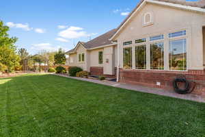 Back of property featuring a tile roof, a gazebo, and stucco siding
