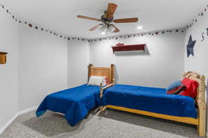 Bedroom featuring baseboards, carpet floors, recessed lighting, and ceiling fan