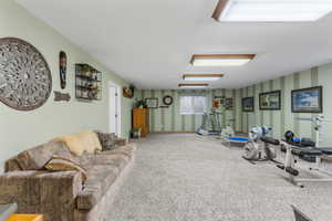 Living room with wallpapered walls and carpet floors