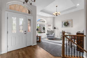 Entryway featuring wood finished floors, baseboards, recessed lighting, and a chandelier