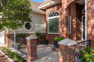 Doorway to property with brick siding and stucco siding