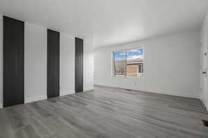 Spare room featuring baseboards and wood finished floors