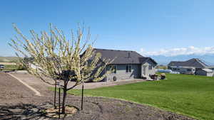 Back of property featuring a lawn and a patio area