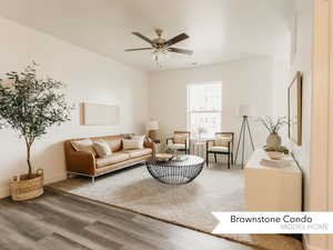 Living area featuring visible vents, baseboards, wood finished floors, and ceiling fan