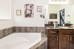 Bathroom with a bath and vanity