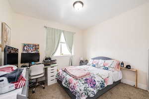 Carpeted bedroom with baseboards