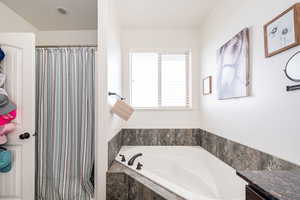 Full bath with a bath and a shower with shower curtain