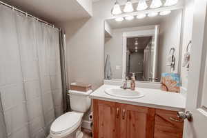 Full bathroom with toilet and vanity