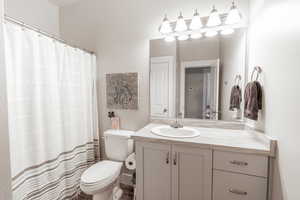 Full bathroom with toilet and vanity