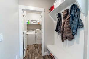 Mudroom featuring dark wood finished floors and separate washer and dryer
