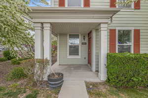 View of exterior entry with covered porch