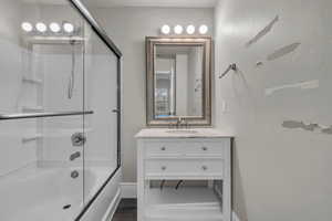 Primary bathroom with vanity, and combined bath /shower with glass door
