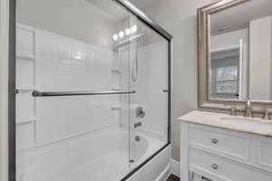 Primary bathroom with vanity, and combined bath /shower with glass door