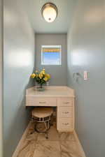 Bathroom featuring marble finish floor and baseboards