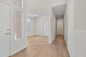 Foyer with baseboards and light wood-style floors