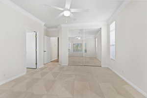 Unfurnished bedroom featuring carpet floors, crown molding, and multiple windows