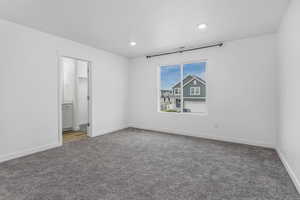 Unfurnished bedroom with recessed lighting, carpet floors, baseboards, and connected bathroom