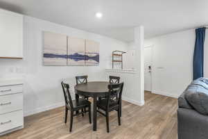 Dining room featuring recessed lighting, light wood finished floors, and baseboards