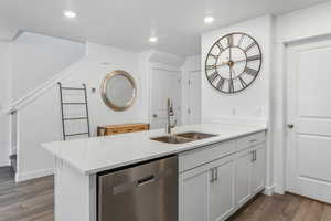 Bar with dishwasher, dark wood-style flooring, a sink, and recessed lighting