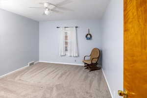 Unfurnished room featuring carpet floors, a ceiling fan, visible vents, and baseboards