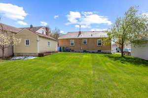 Rear view of property featuring a lawn
