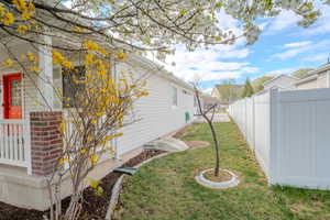 View of yard featuring fence