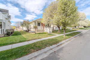 View of front of house featuring a porch, a residential view, and a front yard