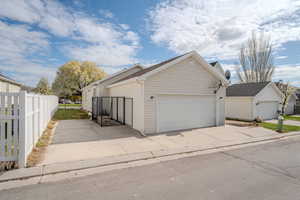 Exterior space with a garage and fence