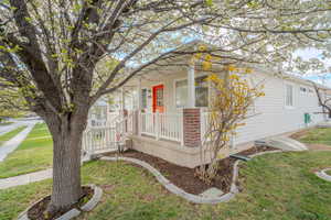 View of side of property with a lawn and brick siding