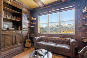Living area with a healthy amount of sunlight and crown molding