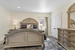Bedroom with baseboards, a closet, and recessed lighting