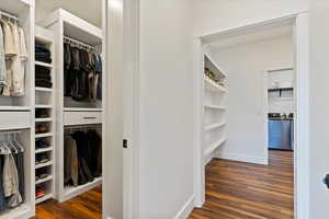 Spacious closet with washer / clothes dryer and wood finished floors