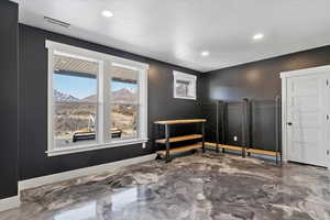 Empty room featuring baseboards, visible vents, recessed lighting, and a textured ceiling