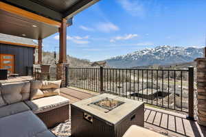 Balcony with an outdoor living space with a fire pit and a mountain view