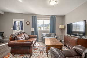 Living area with plenty of natural light, baseboards, and light wood-type flooring