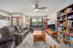 Living area with a ceiling fan, wood finished floors, recessed lighting, and a textured ceiling