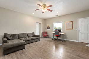 Living area featuring visible vents, a ceiling fan, wood finished floors, and recessed lighting