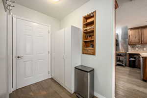 Hallway featuring a textured ceiling and hardwood / wood-style flooring