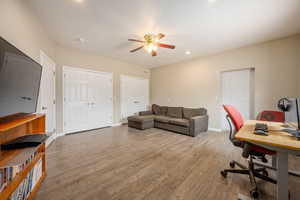 Home office with ceiling fan, baseboards, wood finished floors, and recessed lighting