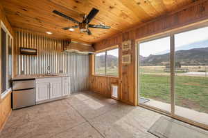 Unfurnished sunroom featuring a sink and a mountain view