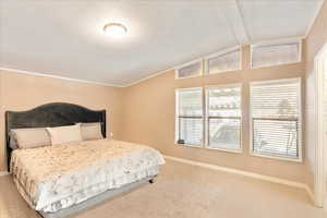 Bedroom with baseboards, carpet, and lofted ceiling with beams