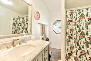 Full bath featuring a shower with shower curtain and vanity