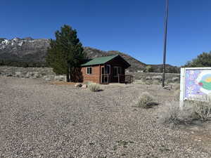 Back of house featuring faux log siding, metal roof, and a mountain view