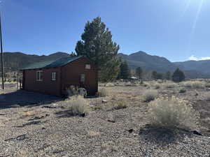 View of home's exterior featuring an outdoor structure and a mountain view