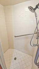Full bath featuring tiled shower