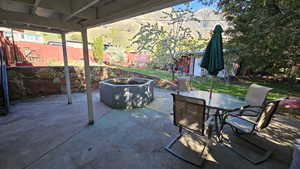 View of patio with fence and outdoor dining space