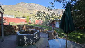 View of patio featuring fence and a mountain view
