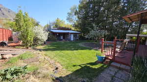 View of yard featuring a deck with mountain view
